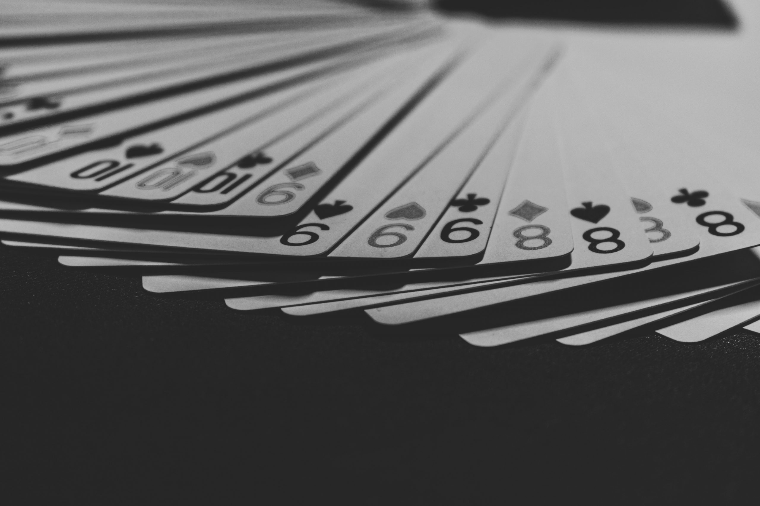 grayscale photo of a fanned playing card